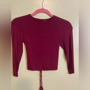 Size small maroon colored top with lace up tie in the back